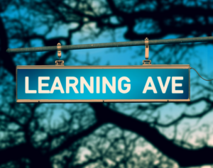 street sign that says "Learning Ave"