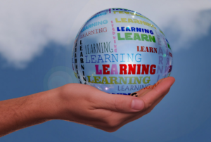 hand holding a globe that says "learning"