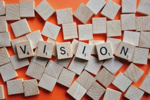 scrabble tiles spelling the word "vision"