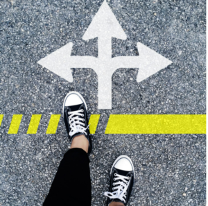 person's feet on pavement with arrows showing three different directions