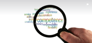 hand holding a magnifying glass with the word "competence" magnified. Other words include "professionalism," "responsibility," and "flexibility."