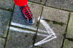 foot on pavement, with arrow pointing only one way