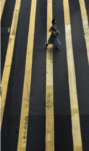 woman walking in crosswalk