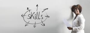 woman at whiteboard with "Skills" written on it