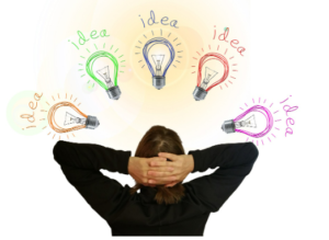 person with hands behind her head, looking upward at lightbulbs that each say "idea"