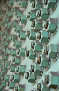 nuts and bolts mounted on a surface
