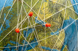 locations linked on a globe with string and push pins