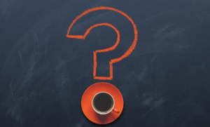question mark, with a coffee cup and saucer creating the dot under the question mark