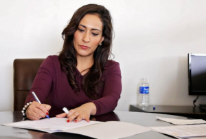 business woman writing at a desk