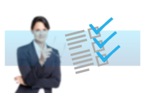 businesswoman in background and checklist with boxes checked