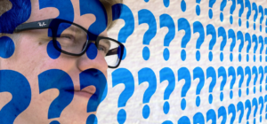 face with multiple question marks superimposed