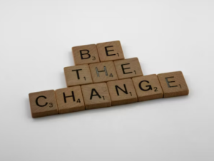 scrabble tiles spelling the phrase "be the change"