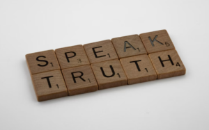 scrabble tiles spelling the phrase "speak truth"