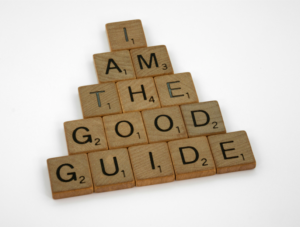 scrabble tiles spelling the phrase "I am the good guide"