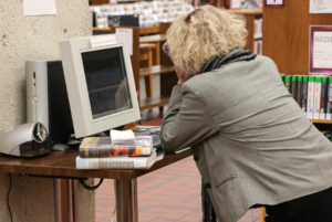 person doing a search on a library computer