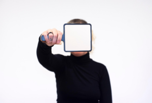 person holding mirror in front of their face