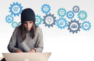 person at laptop with cogs showing thoughts in the background